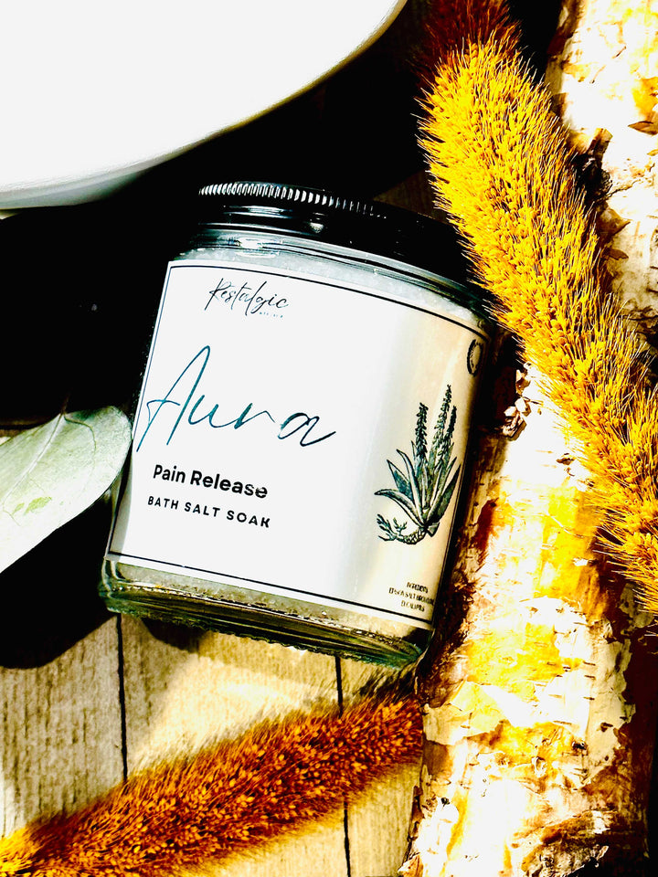 Aura Pain Release bath salt soak jar with black lid and white label