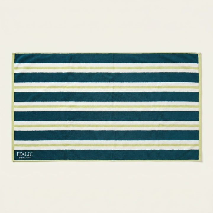 Cotton beach towel with navy and white horizontal stripes, teal binding, ITALIC tag