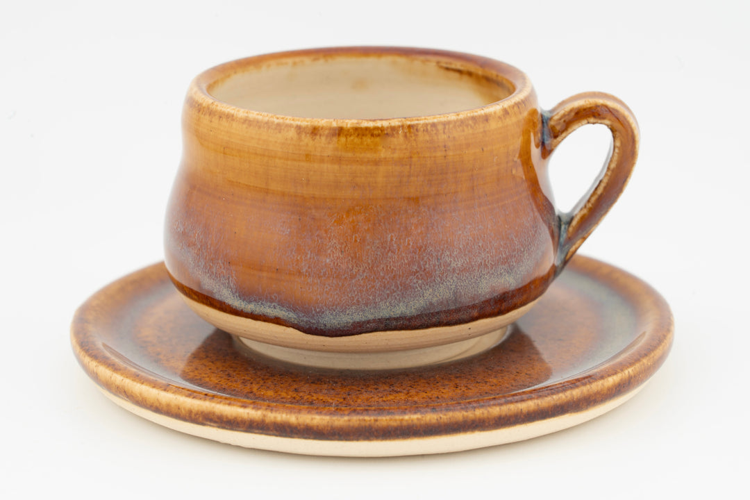 Ceramic espresso cup and saucer set, amber-brown glaze with speckled finish