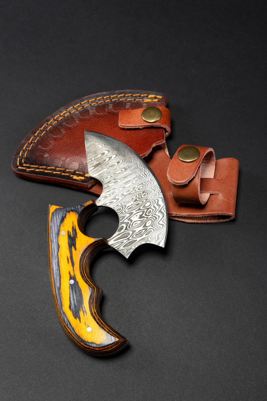 Damascus ulu-style knife with orange wood handle and brown leather sheath