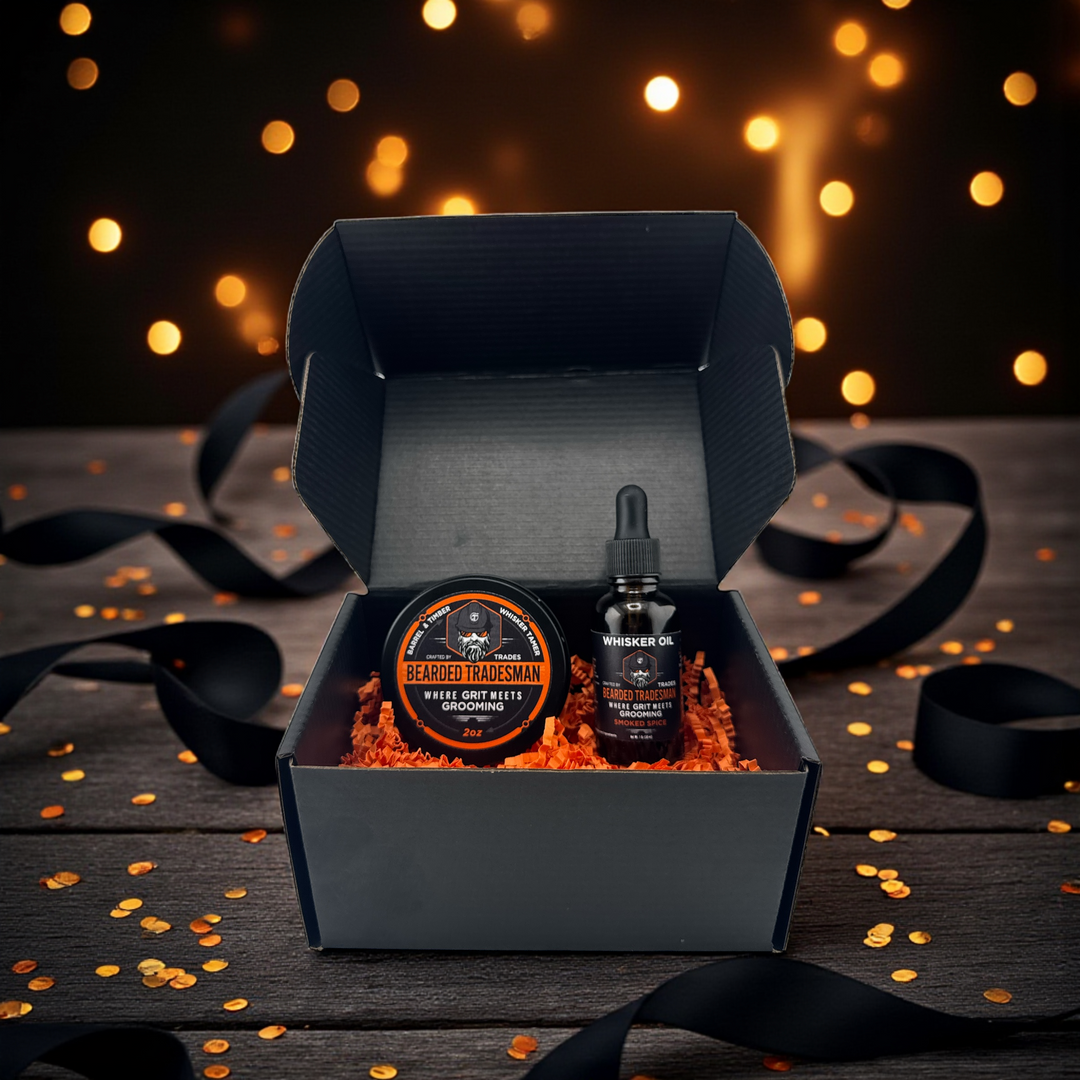 Open dark gift box with round beard balm tin and two oil bottles
