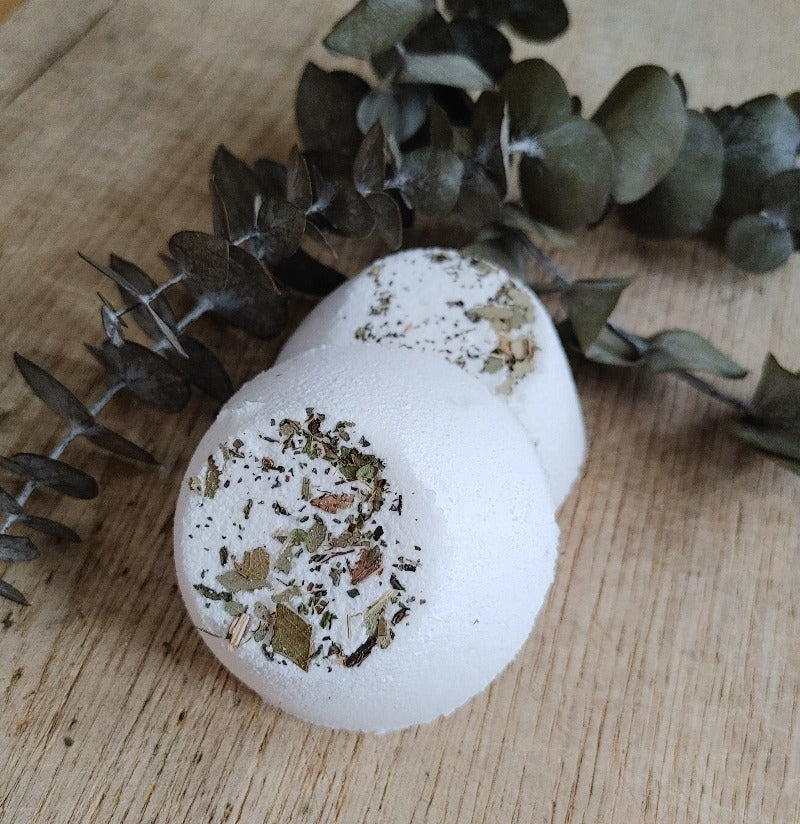 White eucalyptus peppermint shower steamer tablet with dried herb specks