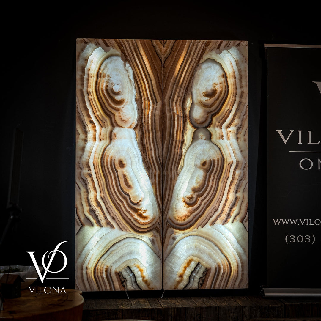 Sahara onyx wall panel with tall vertical panels featuring cream stone bands and oval geodes.