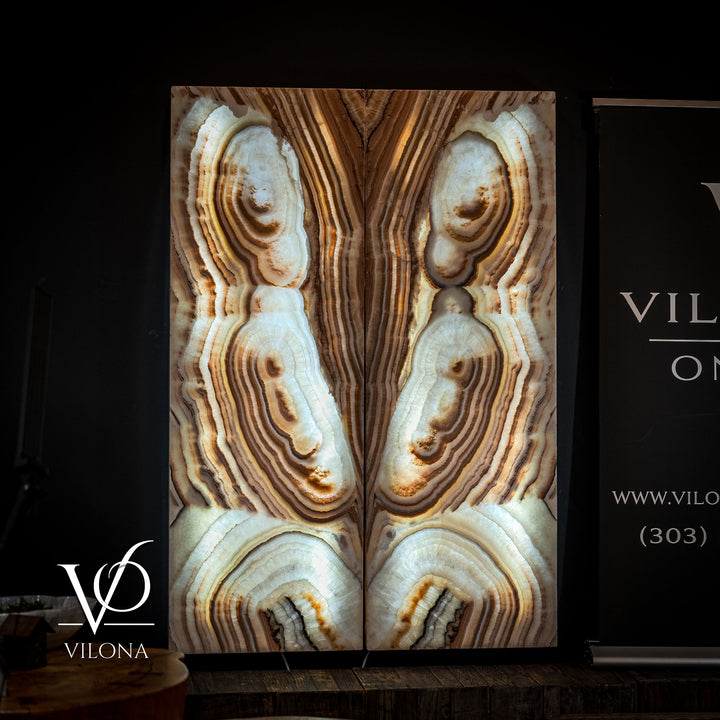 Sahara onyx wall panel with tall vertical panels featuring cream stone bands and oval geodes.
