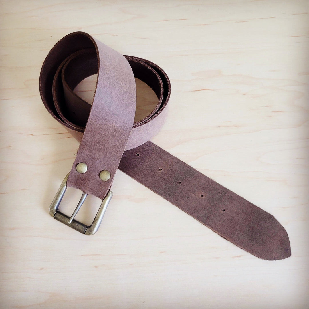 Distressed brown leather belt with metal buckle and punched holes, strap loop view