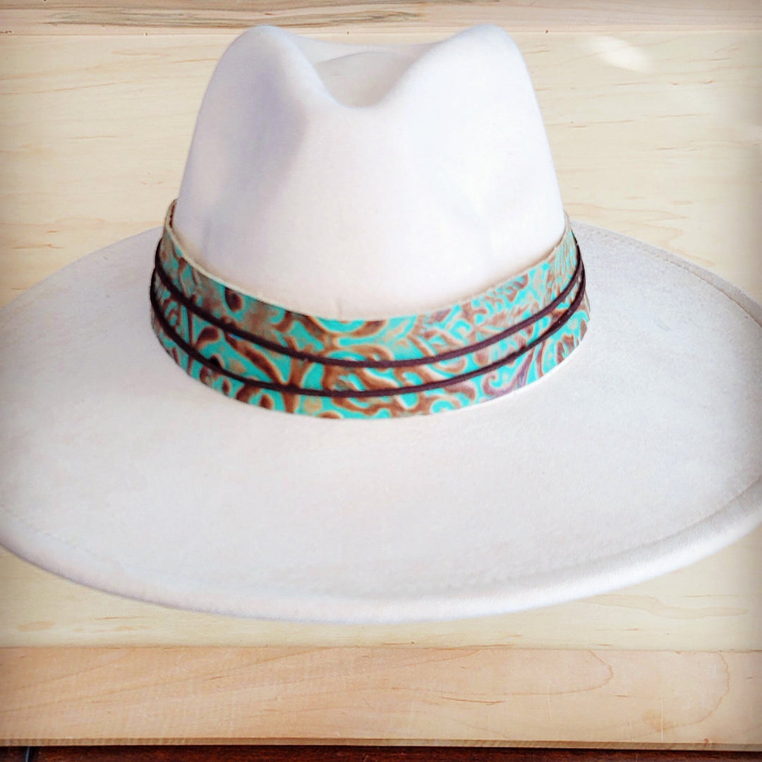 Turquoise leather cowboy hat band with embossed pattern, viewed from the front-left