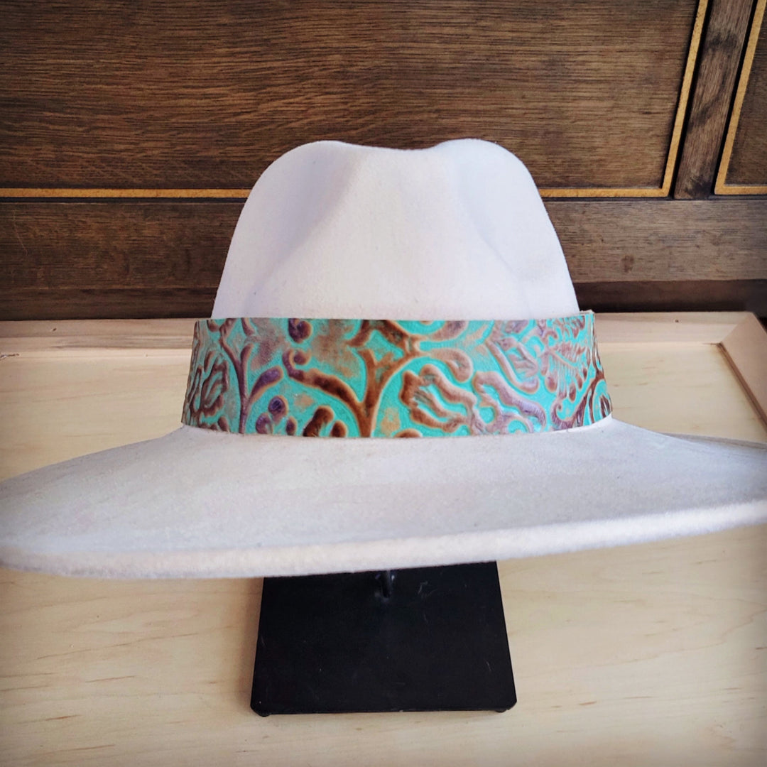 Turquoise leather cowboy hat band with embossed swirl texture and dark trim