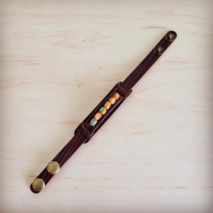 Narrow brown leather cuff bracelet with rectangular row of multicolor stone pieces