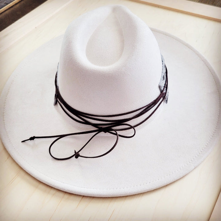 Wide-brim white hat with black drawstring tie at the crown
