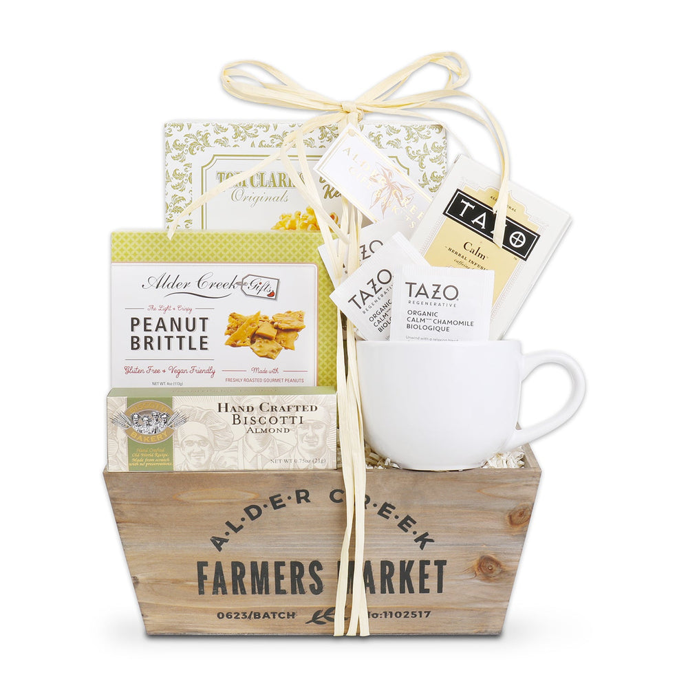 Tea gift basket with wooden crate, white mug, tea packets, peanut brittle and biscuits