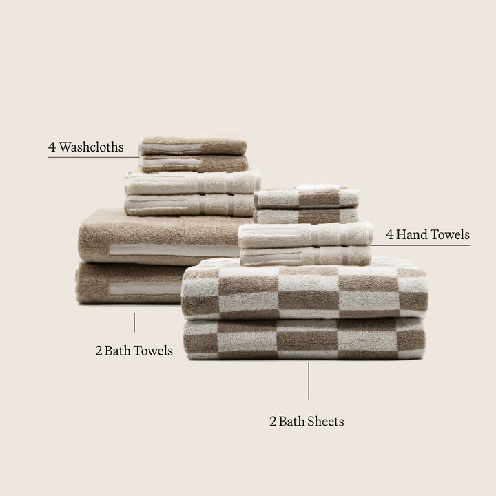 Assorted beige and white checkered towels stack with labeled washcloths and bath sheets