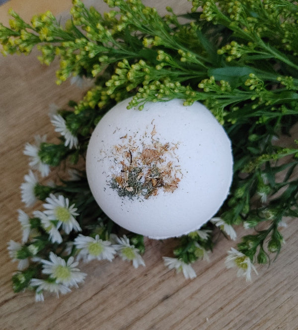 White round bath bomb with brown herbal speckles, Chamomile and Sage scent