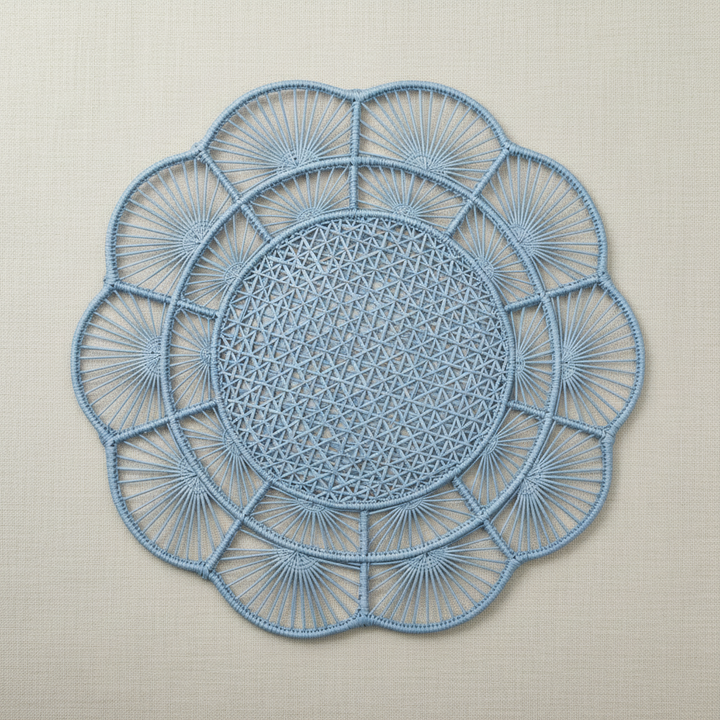 Handwoven iraca placemat in dark navy blue with circular floral fan weave
