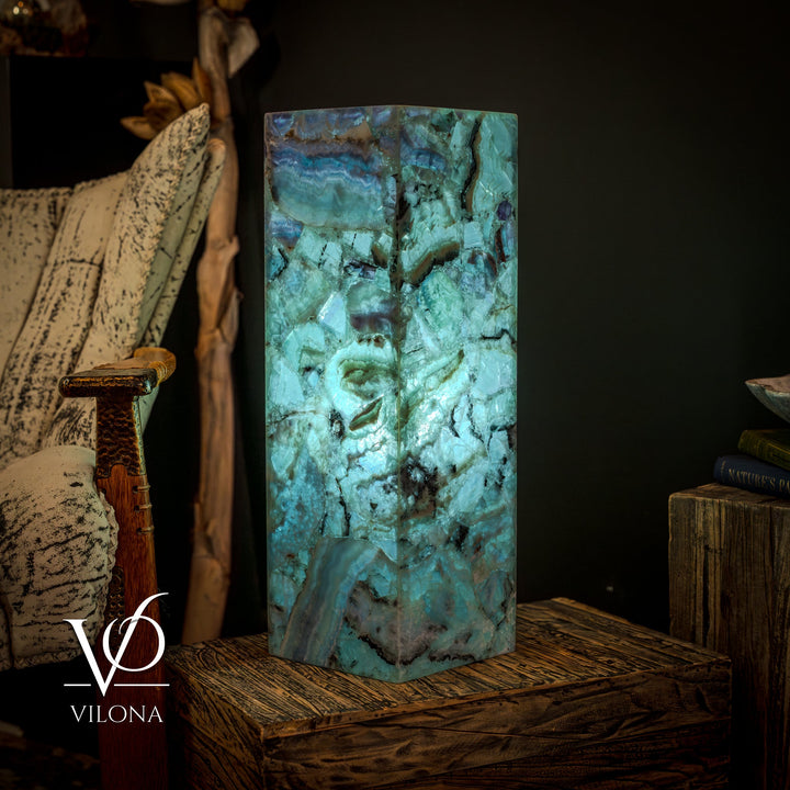 Fluorite crystal table lamp with square, teal-blue glowing prism shade and textured facets