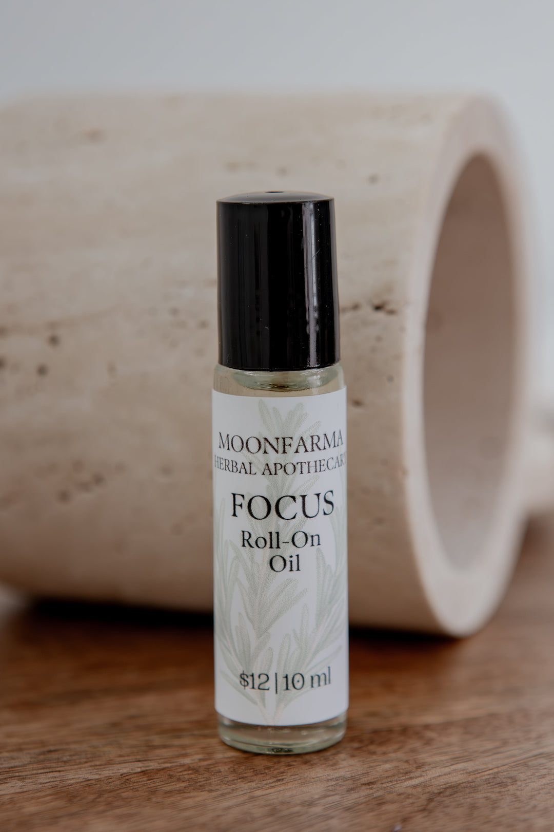 Focus roll-on oil bottle with black cap and clear glass vial, 10 ml