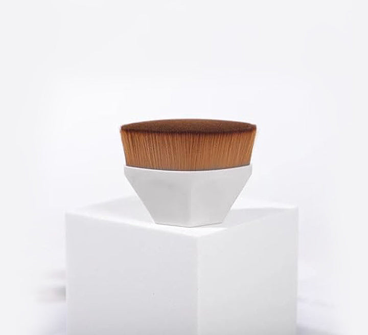 Foundation makeup brush with brown bristles and a white tapered handle cup
