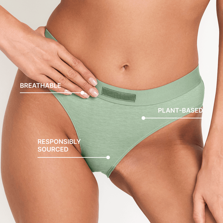 Sage green mid-rise briefs showing waistband and centered back seam on model