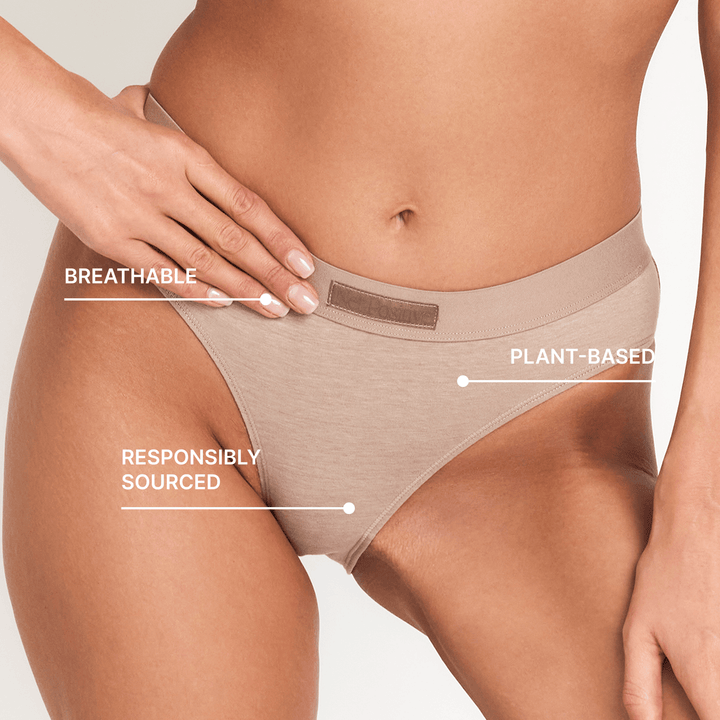 Mid-rise briefs, smooth tan stretch fabric, close-up of waistband and leg opening