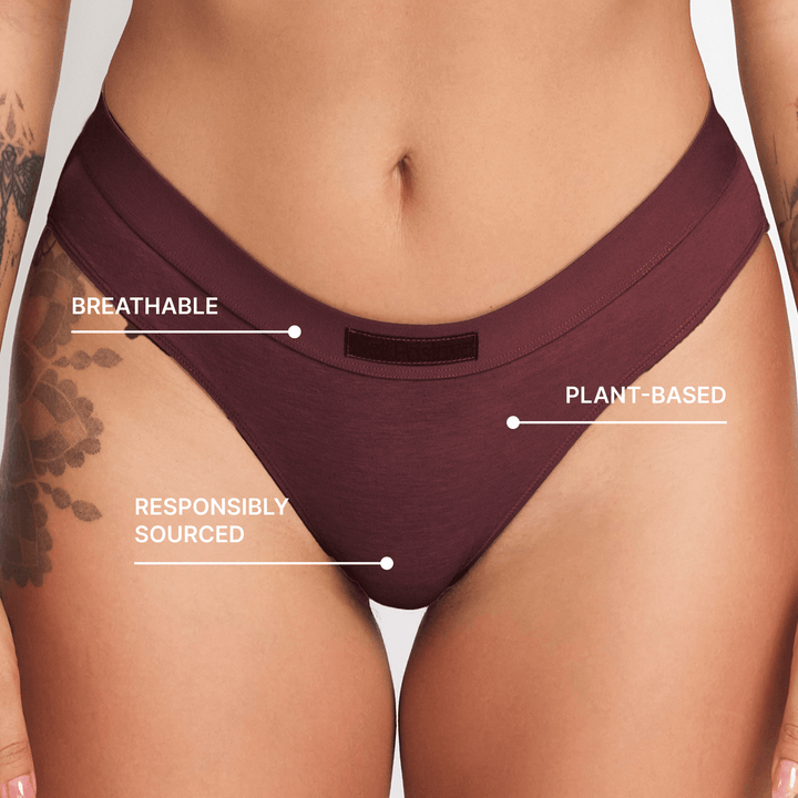 Burgundy mid-rise brief with small back waistband tag and high-cut leg openings.