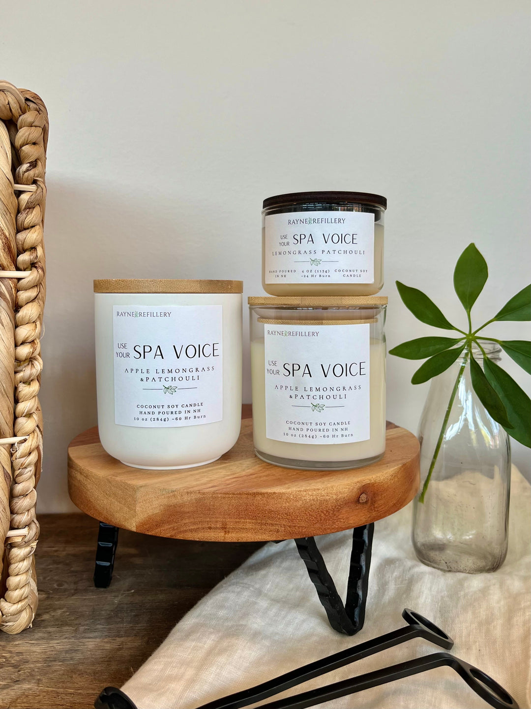Three scented soy candles in white jars, labeled Apple, Lemongrass & Patchouli