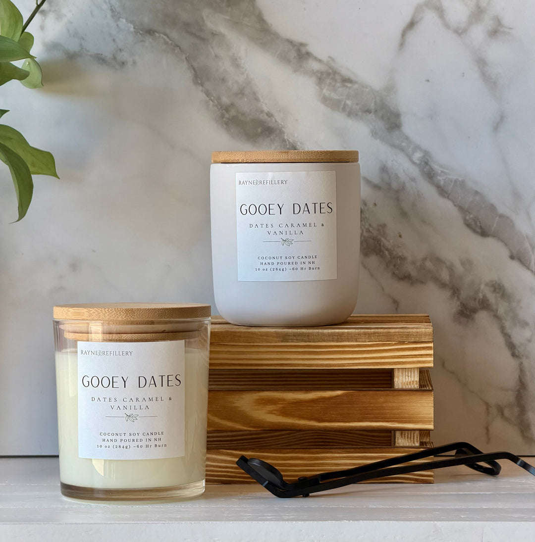 Coconut soy wax candle in white glass jar with tan lid, Gooey Dates label.
