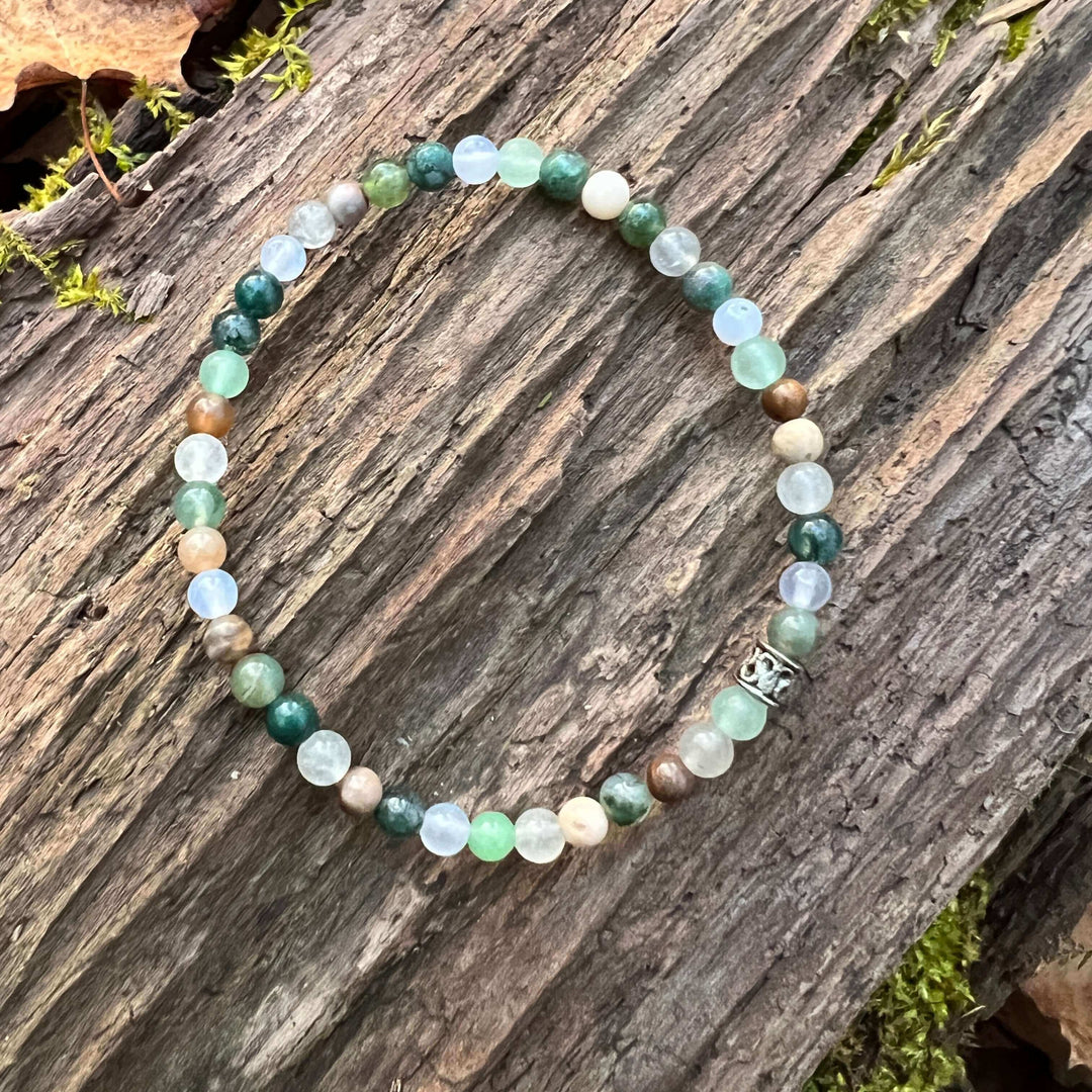 Mini beaded bracelet with round green, blue, and cream stones; silver clasp charm.