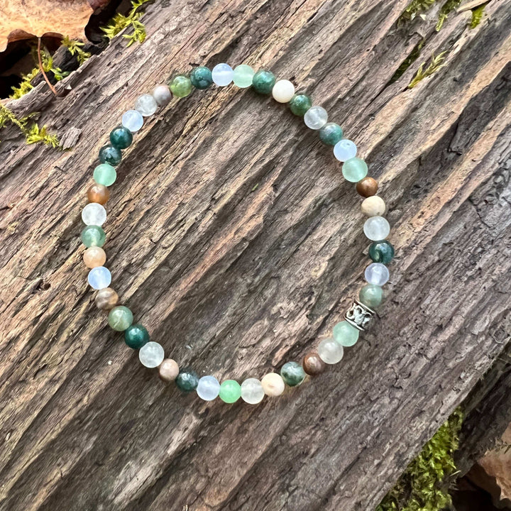 Mini beaded bracelet with round green, blue, and cream stones; silver clasp charm.