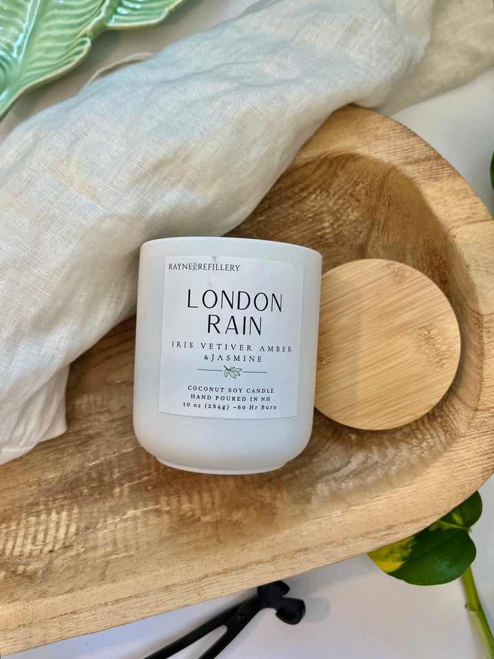 London Rain coconut soy candle in white jar with wooden lid in wooden holder