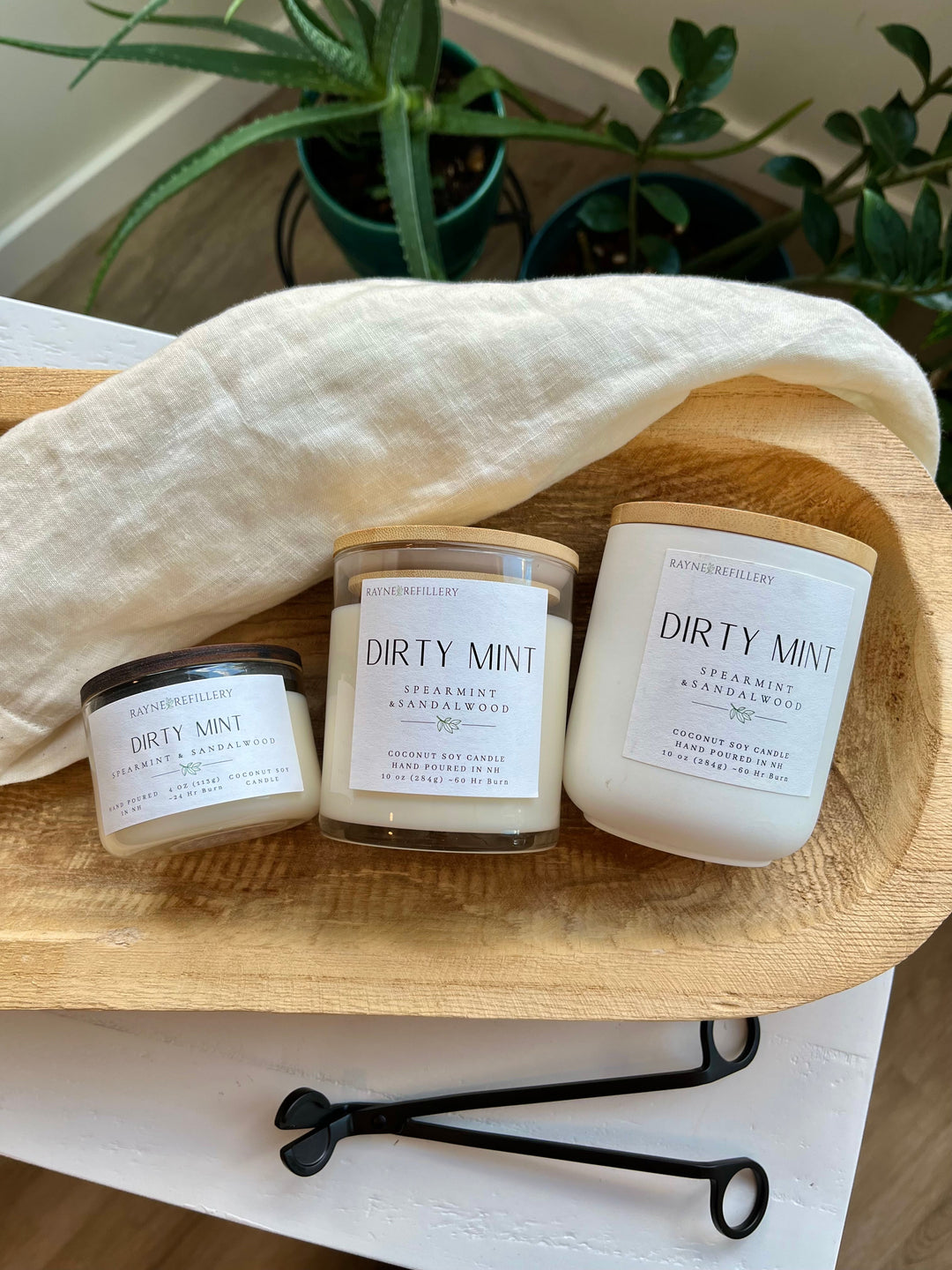 Coconut soy wax candle set of three in clear glass jars on a wooden tray