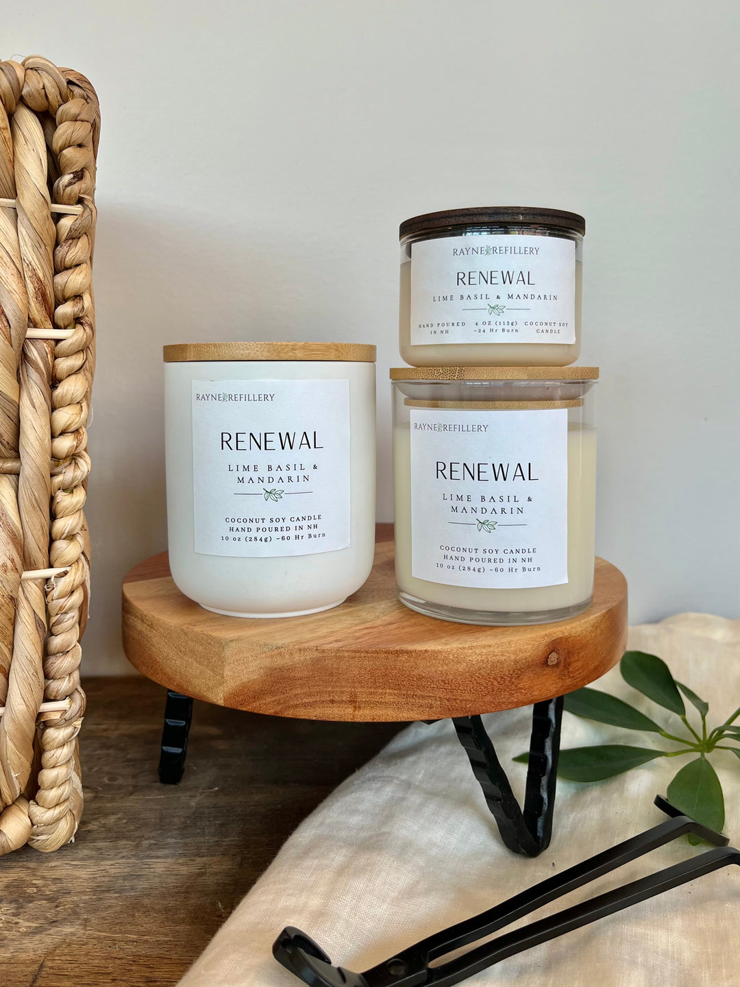 Set of white glass coconut soy candles with lids, labeled RENEWAL