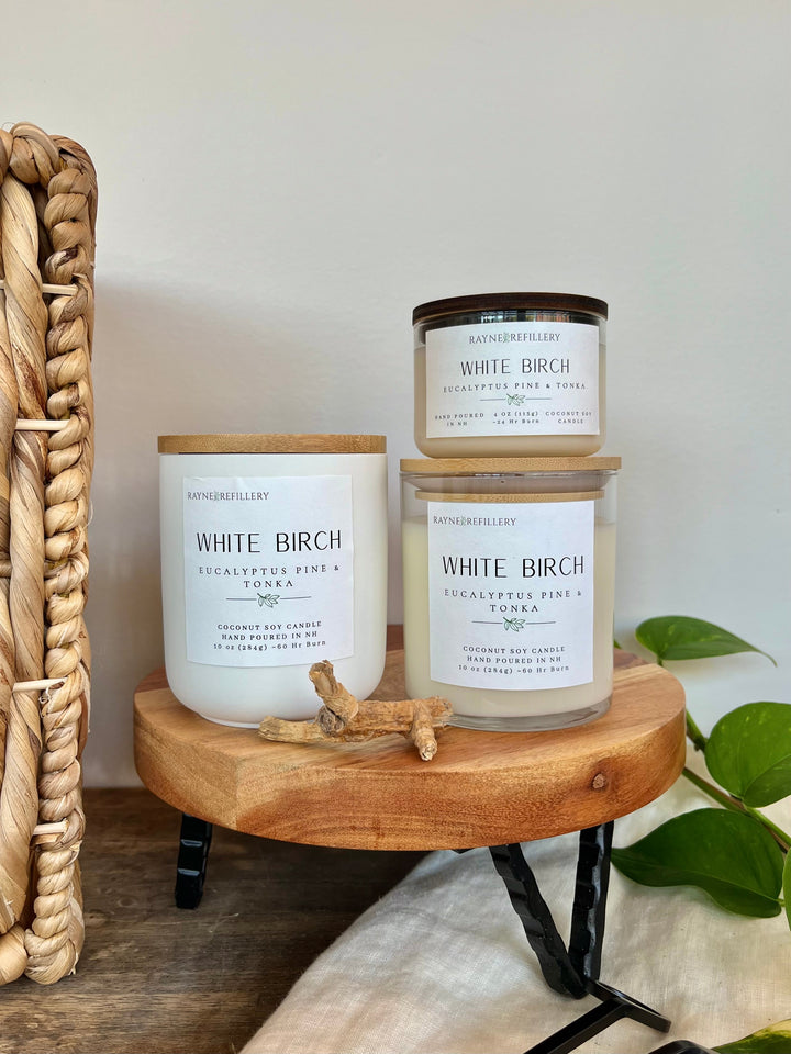 White Birch scented coconut soy candle in white glass jar on wooden tray