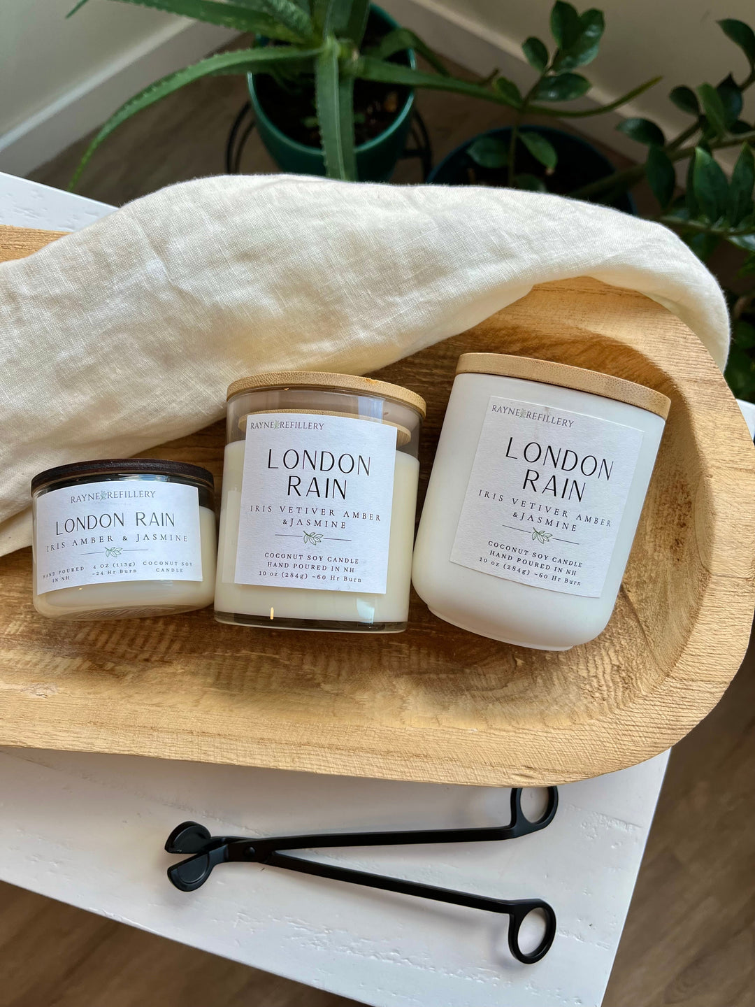 Coconut soy candle set of three in white jars with labels on round wood tray