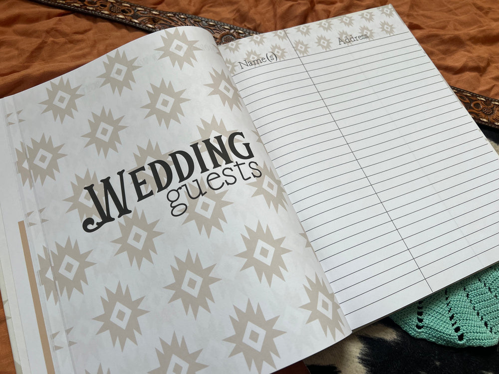 Open wedding book pages with engagement party notes and turquoise beaded decor