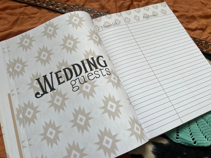 Open wedding book pages with engagement party notes and turquoise beaded decor