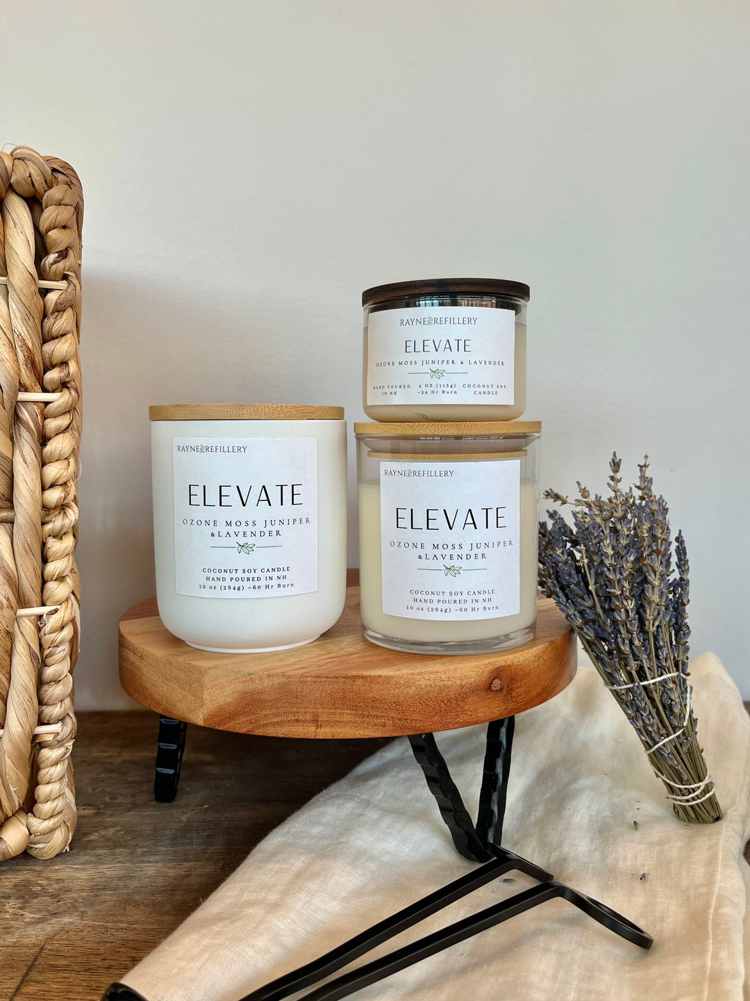 Coconut soy candle set in three labeled glass jars on a wooden tray