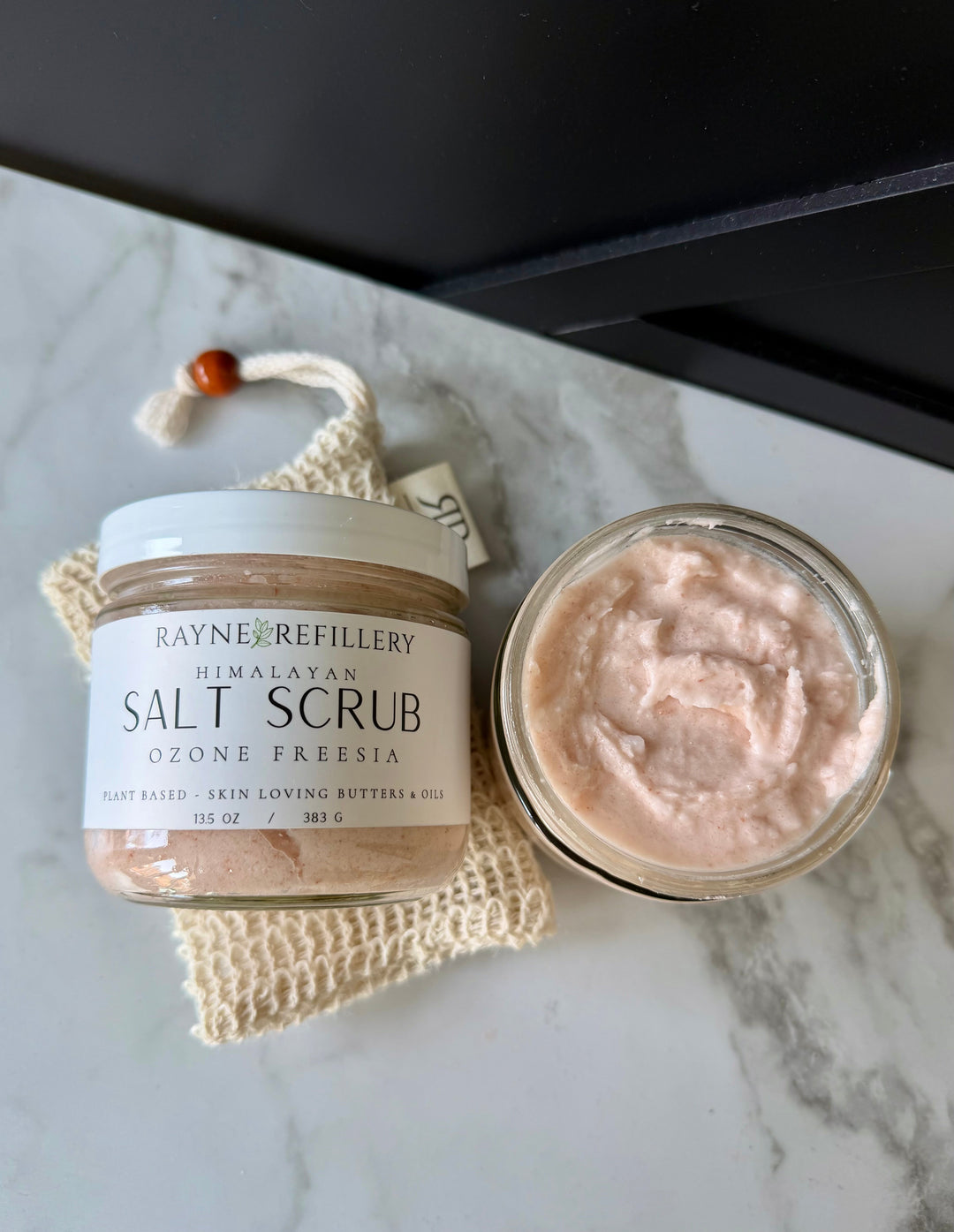 Himalayan salt scrub jar and lid with whipped pink exfoliating cream texture
