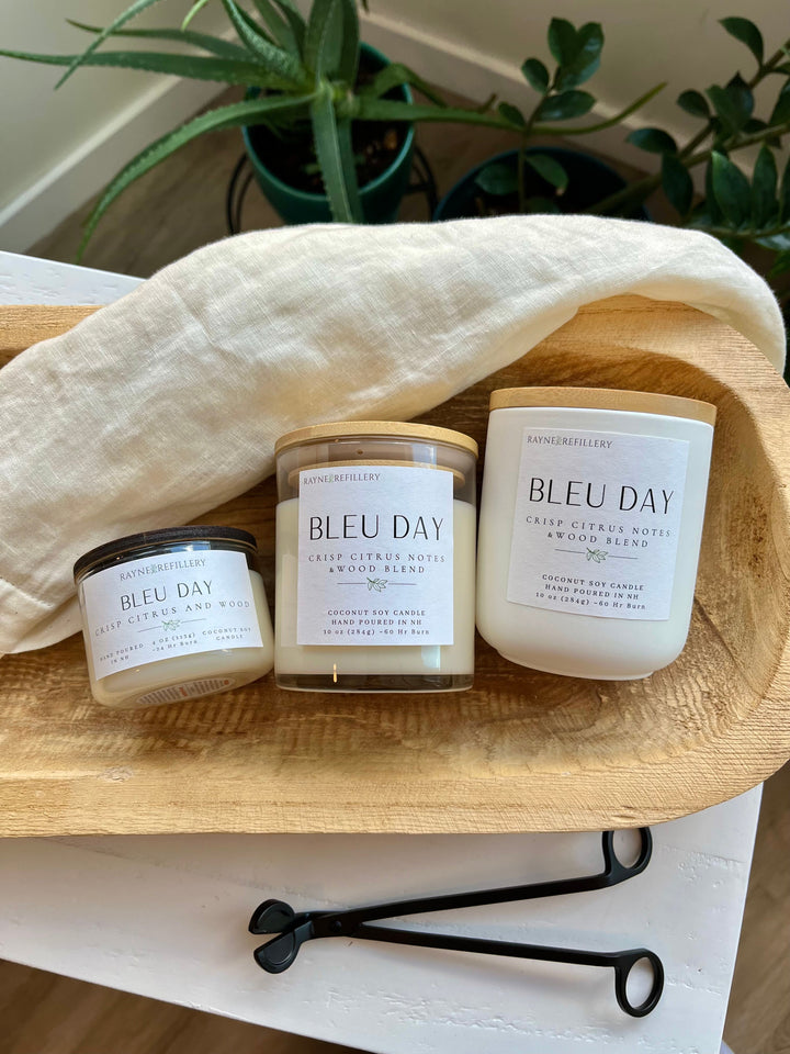 Coconut soy candle trio in white glass jars with gold wick accents on wooden tray