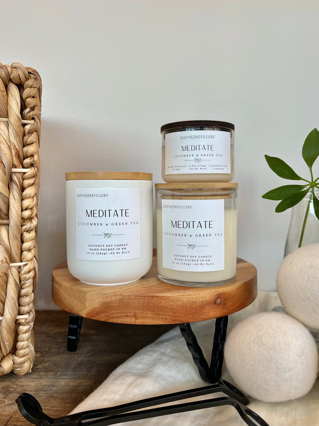 Luxury coconut soy candles in white glass jars with matching wood lids, on tray