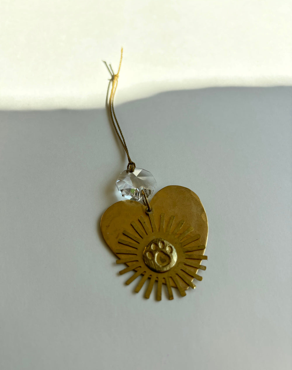 Gold heart ornament with central eye medallion, crystal bead cap, hanging loop