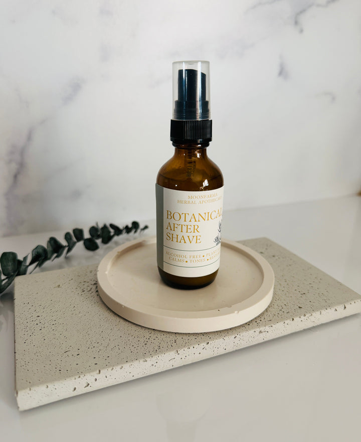 Botanica after shave spray bottle with black pump on a circular base