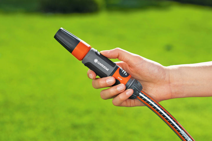 Orange-ring water stop hose connector held in hand with gray ribbed ends