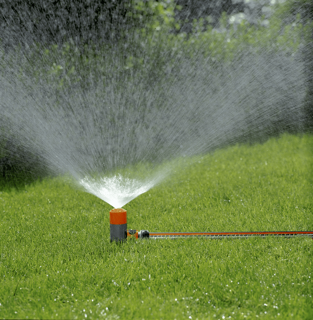 Lawn spike spray sprinkler actively watering with fine water spray
