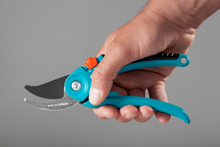 Garden pruners with turquoise handles and black blade, orange release visible