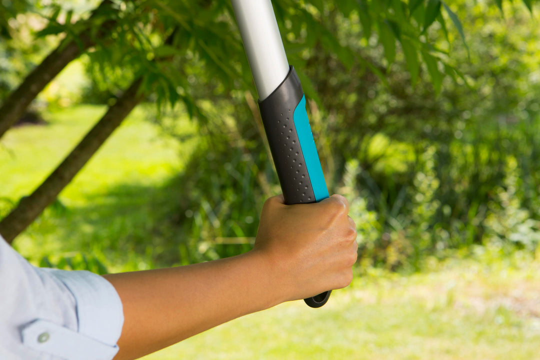 Pruning lopper held in hand with blue grip on the handle