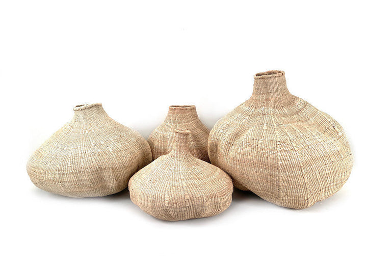 Set of woven sculptural baskets in tan with rounded bellies and narrow openings