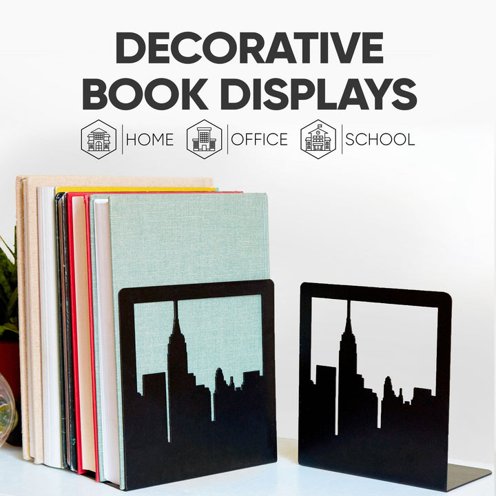 Decorative metal bookends with black skyline silhouettes, standing beside books