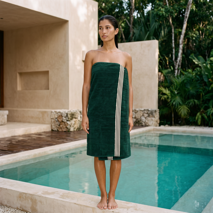 Green Australian cotton towel wrap with white vertical stripes, worn standing by pool