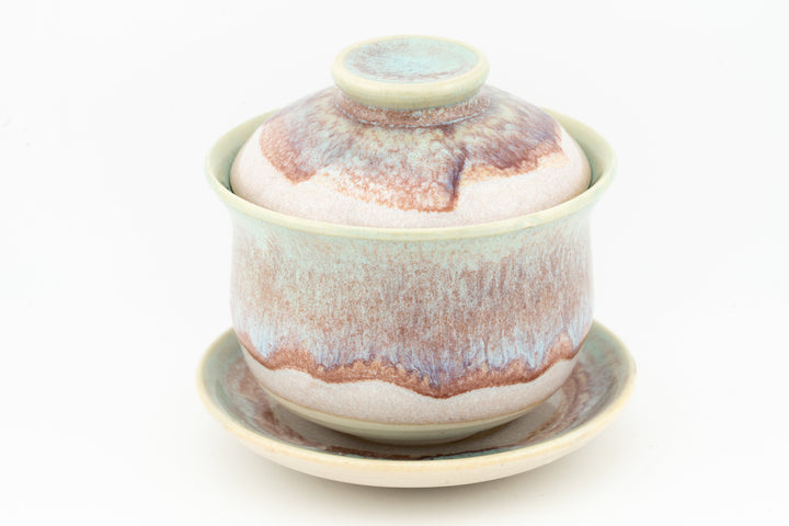 Ceramic gaiwan with multicolor glaze (teal, orange, brown) and matching saucer.
