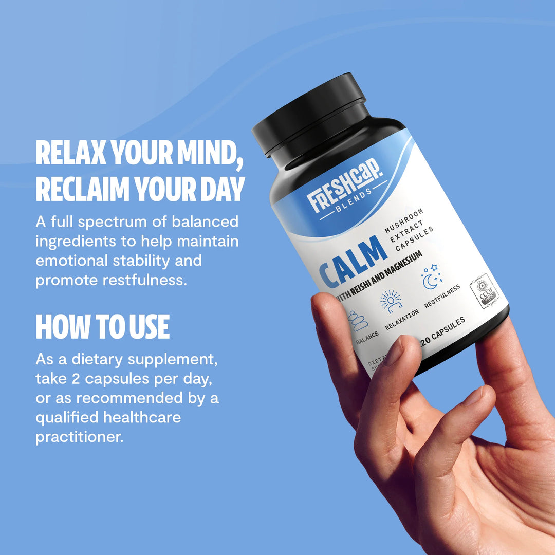Hand holding Calm supplement bottle with blue label and black screw-top cap