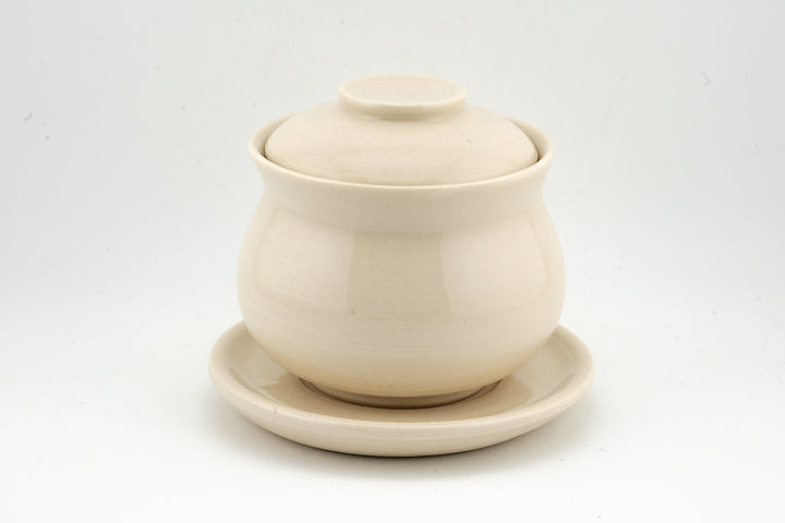 Cream white glazed gaiwan with lid and matching saucer, simple smooth finish.